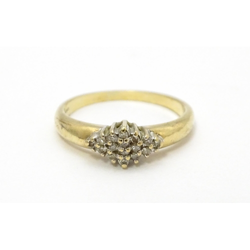 568 - A 9ct gold ring set with diamond cluster. Ring size approx. K 1/2