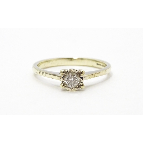 569 - A 9ct white gold ring set with diamond solitaire. Ring size approx. J 1/2