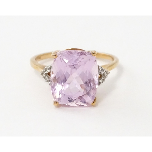 572 - A 9ct rose gold ring set with kunzite flanked by white zircon. Ring size approx. N