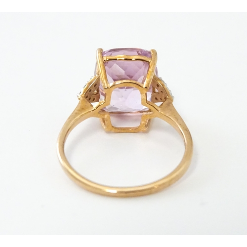 572 - A 9ct rose gold ring set with kunzite flanked by white zircon. Ring size approx. N