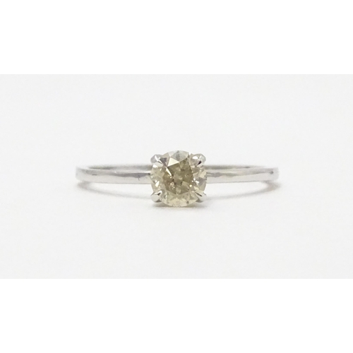 573 - A 14ct white gold ring set with diamond solitaire. Ring size approx. M 1/2