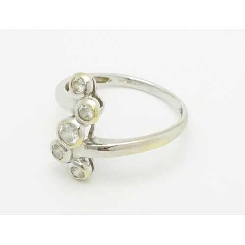 575 - A 14ct white gold ring set with five white stones. Ring size approx. U