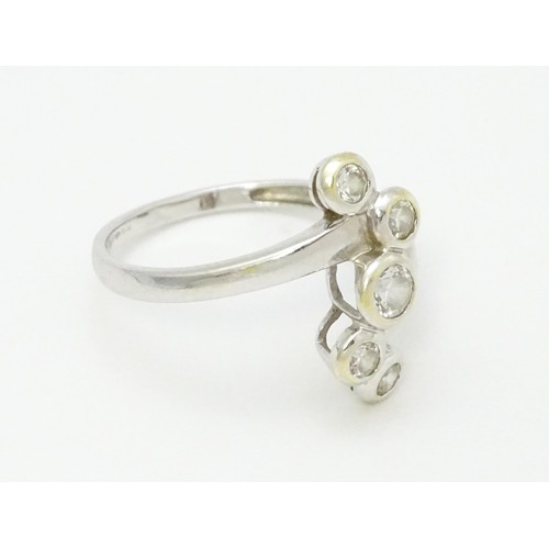 575 - A 14ct white gold ring set with five white stones. Ring size approx. U