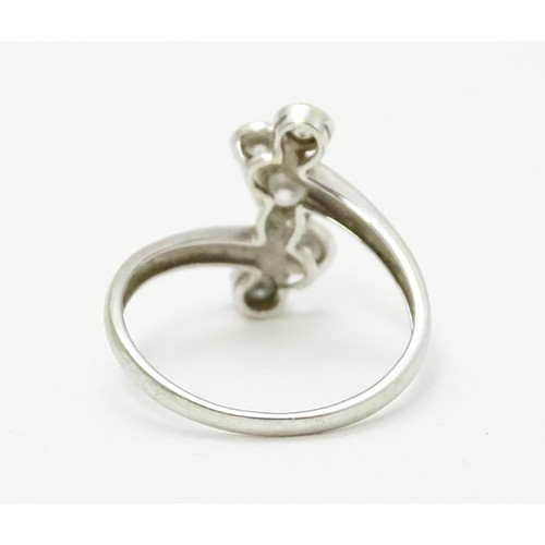 575 - A 14ct white gold ring set with five white stones. Ring size approx. U