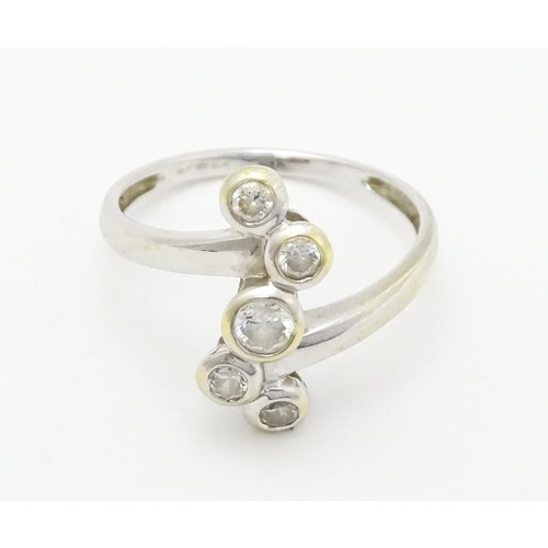 575 - A 14ct white gold ring set with five white stones. Ring size approx. U