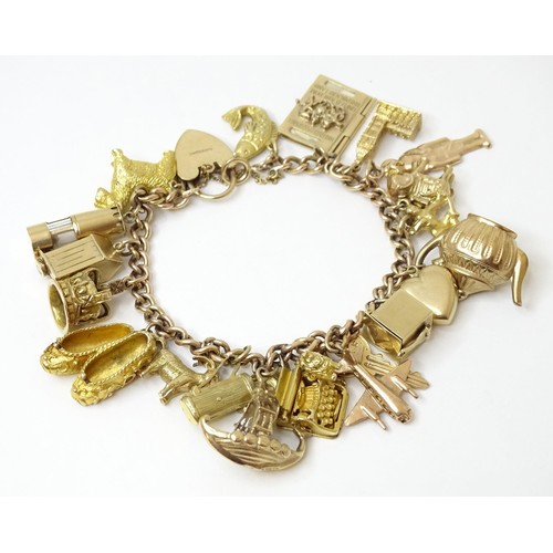 595 - A 9ct gold charm bracelet set with 18 various 9ct gold and some yellow metal charms to include charm... 