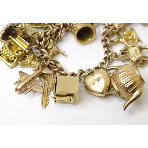 595 - A 9ct gold charm bracelet set with 18 various 9ct gold and some yellow metal charms to include charm... 