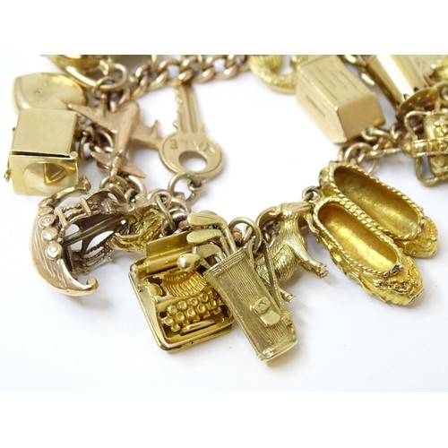 595 - A 9ct gold charm bracelet set with 18 various 9ct gold and some yellow metal charms to include charm... 