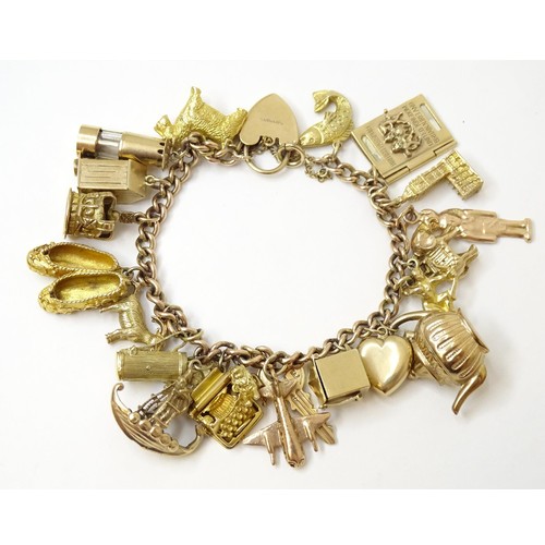 595 - A 9ct gold charm bracelet set with 18 various 9ct gold and some yellow metal charms to include charm... 