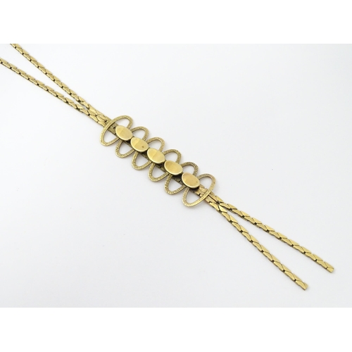 644 - A 9ct gold necklace with textured oval detail to lower section. Bearing import marks for London 1972... 