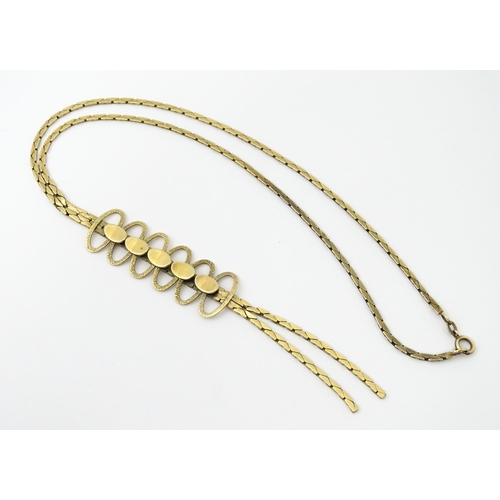 644 - A 9ct gold necklace with textured oval detail to lower section. Bearing import marks for London 1972... 