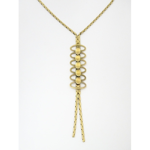 644 - A 9ct gold necklace with textured oval detail to lower section. Bearing import marks for London 1972... 