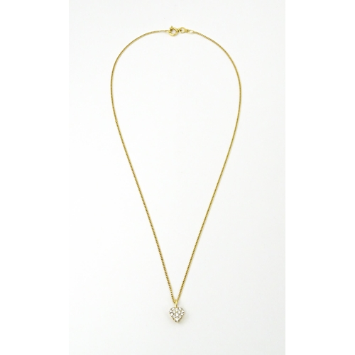 648 - An 18ct gold necklace with heart shaped pendant set with a profusion of diamonds. Approx. 16