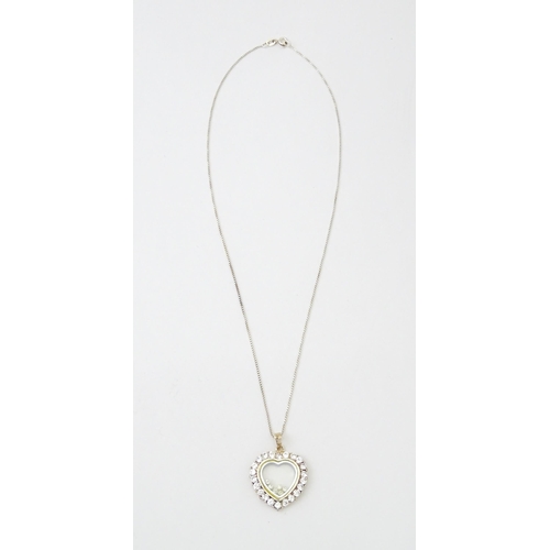 650 - A silver chain with heart shaped locket pendant set with white stones with further white stones with... 