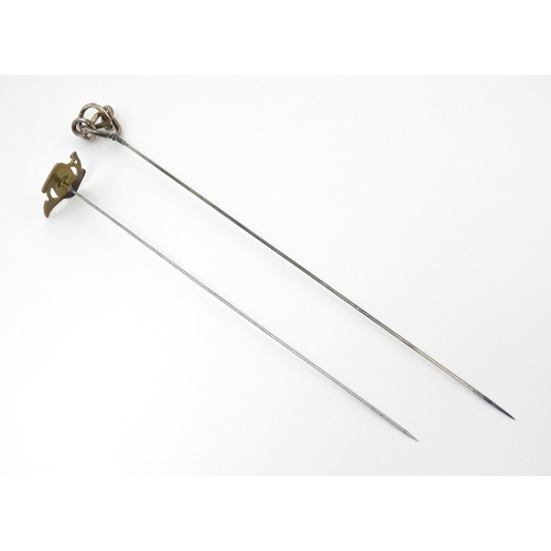 653 - Two hat pins, one surmounted by early 20thC silver detail maker Gourdel Vales & Co, the other surmou... 