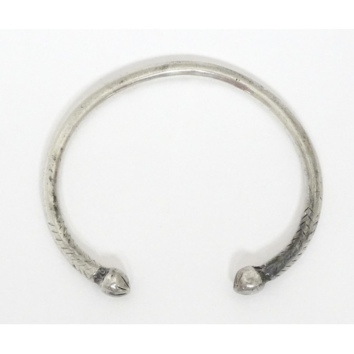 657 - A white metal torque bangle / bracelet