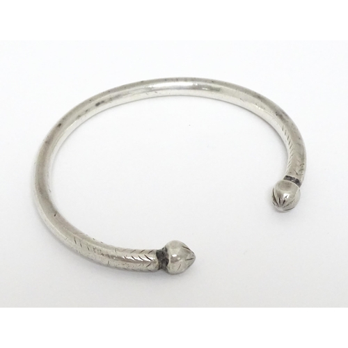 657 - A white metal torque bangle / bracelet