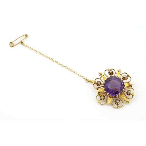 660 - A  Victorian yellow metal brooch of stylised star form set with amethyst seed pearl detail. Together... 