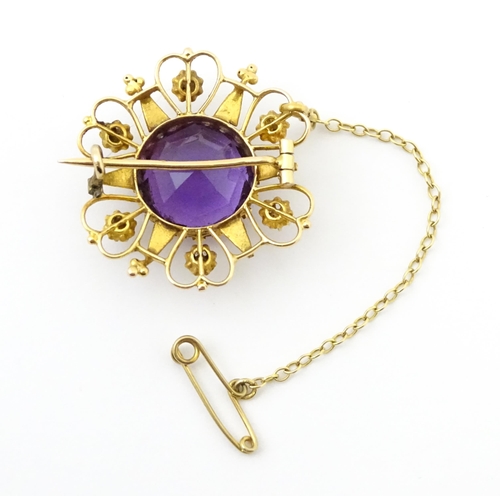 660 - A  Victorian yellow metal brooch of stylised star form set with amethyst seed pearl detail. Together... 