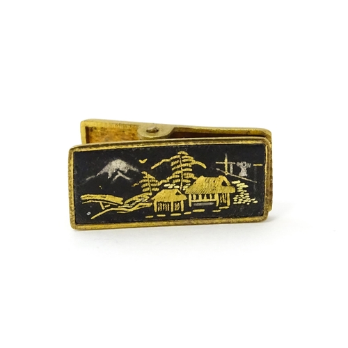 664 - Gilt metal cufflinks, tie pin and clip with Japanese Damascene decoration. Tie pin approx. 2