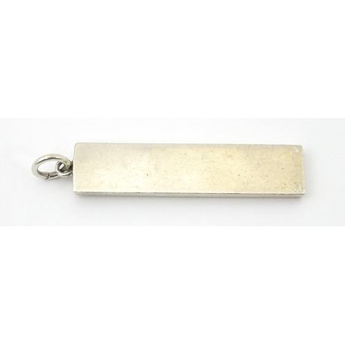 674 - A silver pendant of ingot form, hallmarked Birmingham 197.  Approx. 1 3/4