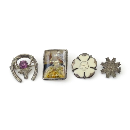 676 - Seven assorted brooches to include some hallmarked silver examples, one formed as a white Yorkshire ... 