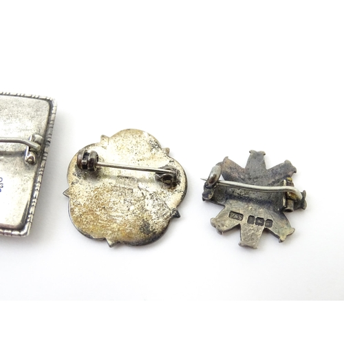 676 - Seven assorted brooches to include some hallmarked silver examples, one formed as a white Yorkshire ... 