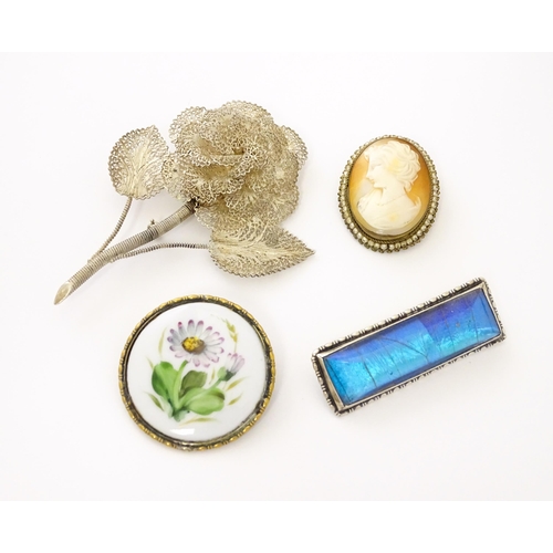 688 - Four brooches comprising a Rosenthal brooch, a gilt metal brooch set with shell carved cameo bordere... 