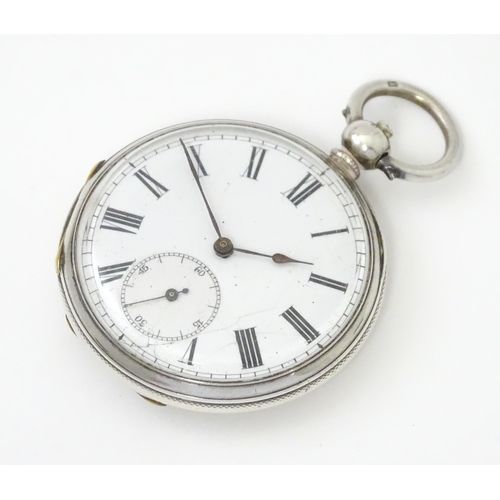 761 - A silver cased pocket watch with white enamel dial, Roman numerals and subsidiary seconds dial.  app... 