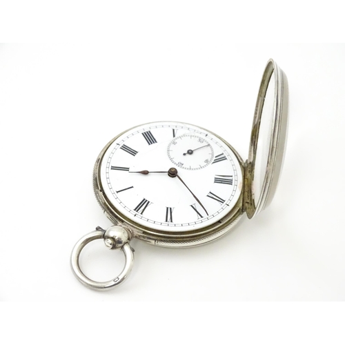 761 - A silver cased pocket watch with white enamel dial, Roman numerals and subsidiary seconds dial.  app... 