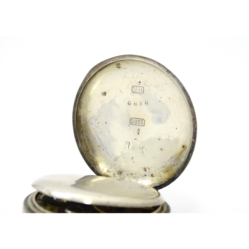 762 - A Swiss silver cased pocket / fob watch with enamel detail and Roman Numerals. Approx 1 /4