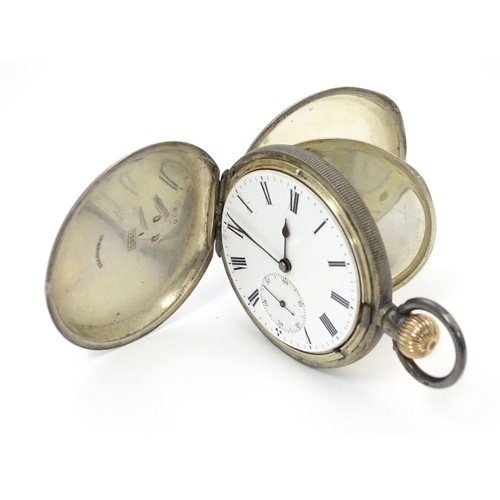 764 - A Swiss silver hunter pocket watch with white enamel dial and subsidiary seconds dial. Engraved Russ... 