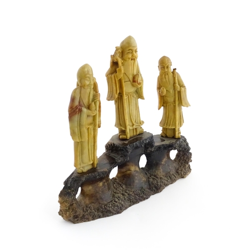 1000 - A Chinese carved soapstone figural group depicting three sage figures. Approx. 8 1/2