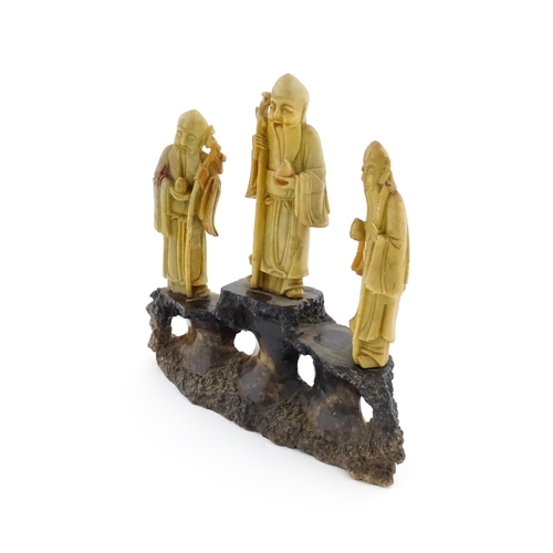 1000 - A Chinese carved soapstone figural group depicting three sage figures. Approx. 8 1/2