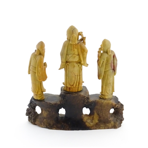 1000 - A Chinese carved soapstone figural group depicting three sage figures. Approx. 8 1/2