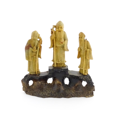 1000 - A Chinese carved soapstone figural group depicting three sage figures. Approx. 8 1/2