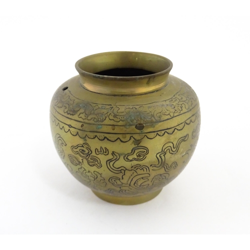 1001 - A Chinese cast brass pot decorated with phoenix, bat, stylised clouds, flowers, etc. Character marks... 