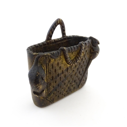 1016 - An Oriental cast model of a basket with two rats. Approx. 3 1/4