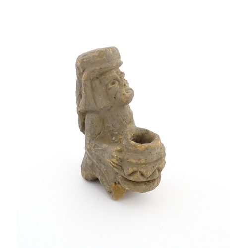 1034 - An Aztec Pre-Columbian style earthenware sculpture depicting a kneeling figure with a vessel. Approx... 