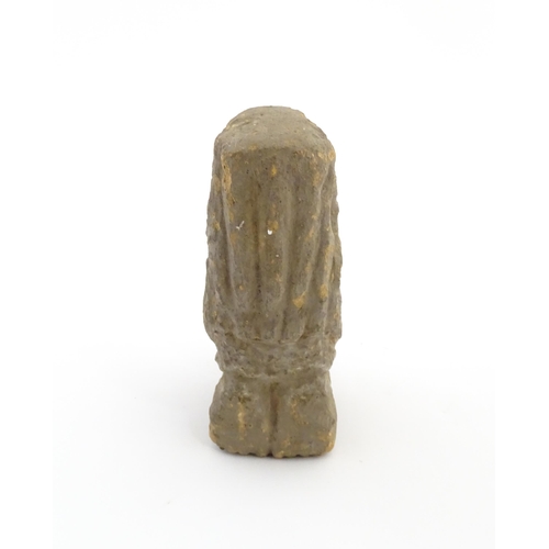 1034 - An Aztec Pre-Columbian style earthenware sculpture depicting a kneeling figure with a vessel. Approx... 