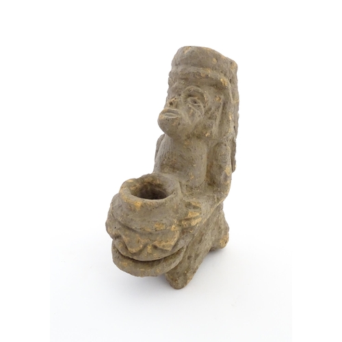 1034 - An Aztec Pre-Columbian style earthenware sculpture depicting a kneeling figure with a vessel. Approx... 