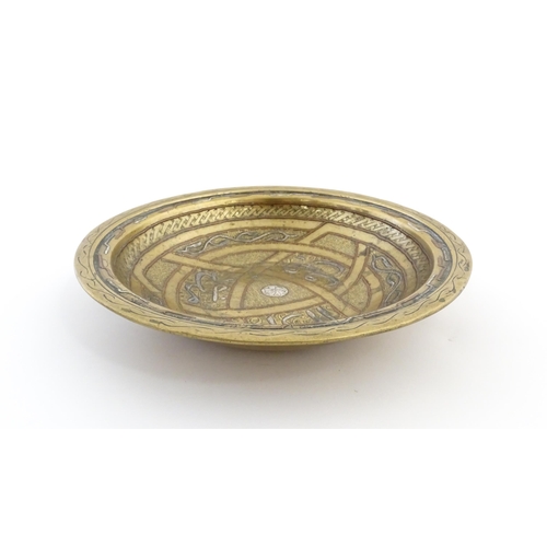 1037 - A Middle Eastern brass dish / bowl with incised detail and inlaid white metal and copper decoration ... 