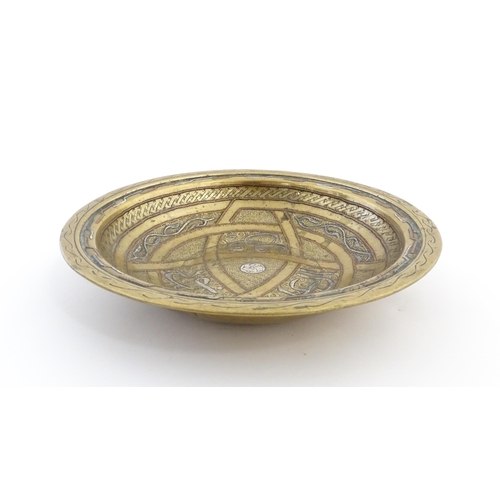 1037 - A Middle Eastern brass dish / bowl with incised detail and inlaid white metal and copper decoration ... 