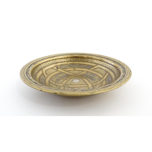 1037 - A Middle Eastern brass dish / bowl with incised detail and inlaid white metal and copper decoration ... 