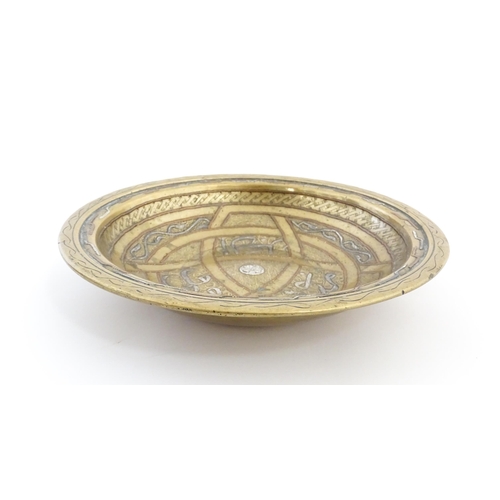 1037 - A Middle Eastern brass dish / bowl with incised detail and inlaid white metal and copper decoration ... 