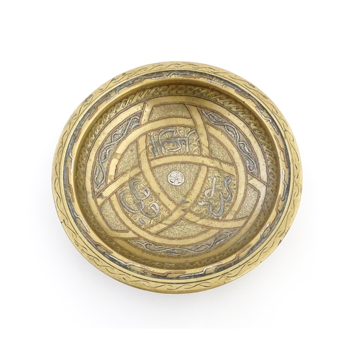 1037 - A Middle Eastern brass dish / bowl with incised detail and inlaid white metal and copper decoration ... 