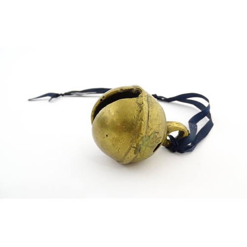 1038 - An Indian brass elephant claw bell. Together with a crotal bell marked AD and HN. Claw bell approx. ... 