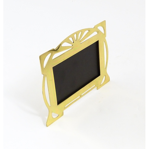 1045 - A late 20thC brass easel back photograph frame with pierced decoration, engraved to reverse 'For you... 