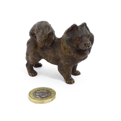 1051 - A 20thC cast bronze model of a dog with red painted eyes. Approx. 2 1/4