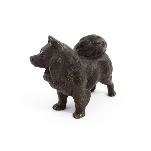 1051 - A 20thC cast bronze model of a dog with red painted eyes. Approx. 2 1/4